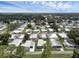 Aerial view of 55+ community with numerous homes and lush landscaping at 411 Palo Verde Dr, Leesburg, FL 34748