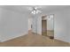 Bright bedroom with mirrored closet doors and wood-look floors at 411 Palo Verde Dr, Leesburg, FL 34748