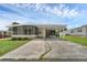 Cute yellow home with carport and screened porch at 411 Palo Verde Dr, Leesburg, FL 34748