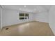 Spacious living room with large windows and wood flooring at 411 Palo Verde Dr, Leesburg, FL 34748