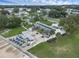 Aerial view of community clubhouse with outdoor seating and lush landscaping at 411 Palo Verde Dr, Leesburg, FL 34748