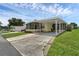 Cute yellow home with carport and screened porch at 411 Palo Verde Dr, Leesburg, FL 34748
