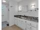 Modern bathroom with granite countertop and double sinks at 411 Palo Verde Dr, Leesburg, FL 34748