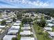 Aerial view of a 55+ community with mature trees and various homes at 411 Palo Verde Dr, Leesburg, FL 34748