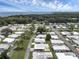 Aerial view of waterfront 55+ community showcasing homes and lake access at 411 Palo Verde Dr, Leesburg, FL 34748
