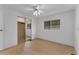 Simple bedroom with mirrored closet and wood-look floors at 411 Palo Verde Dr, Leesburg, FL 34748