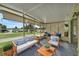 Relaxing screened porch furnished with seating and a table at 411 Palo Verde Dr, Leesburg, FL 34748