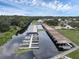 Aerial view of a marina with many boats docked under covered slips at 411 Palo Verde Dr, Leesburg, FL 34748