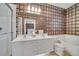 Elegant bathroom with a double vanity, shower, and patterned wallpaper at 11886 Nautica Dr, Orlando, FL 32827