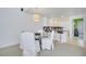 Bright dining area with glass table and white chairs, adjacent to kitchen at 11886 Nautica Dr, Orlando, FL 32827