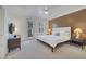 Main bedroom with a king-size bed, nightstands, and access to a balcony at 11886 Nautica Dr, Orlando, FL 32827