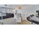 Open dining area with glass table and chairs, adjacent to living room and kitchen at 11886 Nautica Dr, Orlando, FL 32827