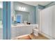 Light blue bathroom with white vanity, toilet, and shower at 11886 Nautica Dr, Orlando, FL 32827