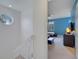 Upstairs hallway with white railing and access to bedrooms at 11886 Nautica Dr, Orlando, FL 32827