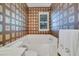 Bathroom with patterned walls, a bathtub, and window at 11886 Nautica Dr, Orlando, FL 32827