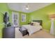 Green bedroom with king-size bed and private door to balcony at 11886 Nautica Dr, Orlando, FL 32827