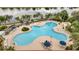 Community pool with surrounding lounge chairs and umbrellas at 11886 Nautica Dr, Orlando, FL 32827