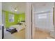 Bedroom with lime green walls, queen bed, and en-suite bathroom at 11886 Nautica Dr, Orlando, FL 32827