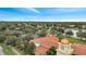 Aerial view of community, including pool, tennis courts, and clubhouse at 11886 Nautica Dr, Orlando, FL 32827