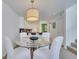 Bright dining room with glass table and chairs, open to kitchen at 11886 Nautica Dr, Orlando, FL 32827
