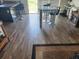 Dining area with dark wood-look flooring and a glass top table at 1322 Conch Key Ln, Davenport, FL 33837