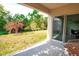 View of the backyard from the covered patio with sliding glass doors at 2836 Sunridge Loop, Saint Cloud, FL 34771