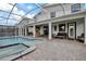 Resort-style backyard oasis with pool, spa, and patio furniture at 9210 Sommerset Hills Dr, Davenport, FL 33896