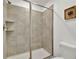 Shower with neutral tile and glass enclosure at 9210 Sommerset Hills Dr, Davenport, FL 33896