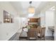 Condo kitchen with wood cabinets and a dining area with glass table and four chairs at 12527 Floridays Resort Dr # 312-E, Orlando, FL 32821