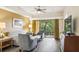 Comfortable living room with gray sofa and chairs, plus a balcony view at 12527 Floridays Resort Dr # 312-E, Orlando, FL 32821