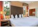 King-size bed and ensuite bath with window access in this Primary bedroom at 12527 Floridays Resort Dr # 312-E, Orlando, FL 32821