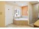 Bathroom with corner tub, shower, and double vanity at 12527 Floridays Resort Dr # 312-E, Orlando, FL 32821