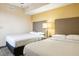 Bedroom with two double beds and nightstand at 12527 Floridays Resort Dr # 312-E, Orlando, FL 32821