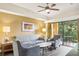 Living room with gray sofa and chairs, coffee table, and access to a balcony at 12527 Floridays Resort Dr # 312-E, Orlando, FL 32821