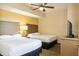 Bedroom with two double beds, ceiling fan, and TV at 12527 Floridays Resort Dr # 312-E, Orlando, FL 32821