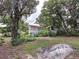 Older home exterior with overgrown landscaping at 1079 Marion St, Lake Helen, FL 32744