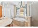 Elegant bathroom featuring a soaking tub, walk-in shower, and updated vanity at 1257 Radiant St, Reunion, FL 34747