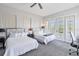 Spacious bedroom with two twin beds, a desk, and access to a balcony at 1257 Radiant St, Reunion, FL 34747