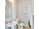 Small powder room with sink, toilet, and decorative mirror at 1257 Radiant St, Reunion, FL 34747