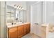 Clean bathroom with a walk-in shower, double vanity, and a view of the bedroom at 1257 Radiant St, Reunion, FL 34747