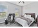 Bright bedroom with a queen bed, a workspace, and large windows at 1257 Radiant St, Reunion, FL 34747