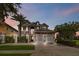 Two-story house with stone and stucco exterior, three-car garage, and landscaping at 1257 Radiant St, Reunion, FL 34747