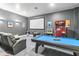 Basement game room with pool table, theater seating, and arcade game at 1257 Radiant St, Reunion, FL 34747