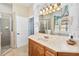 Bathroom with a vanity, shower, and access to another room at 1257 Radiant St, Reunion, FL 34747