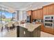 Bright kitchen features granite countertops, island, and view to golf course at 1257 Radiant St, Reunion, FL 34747