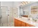 Large bathroom with a walk-in shower, double vanity, and updated fixtures at 1257 Radiant St, Reunion, FL 34747