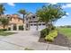 Two-story house with stone and stucco exterior, three-car garage, and landscaping at 1257 Radiant St, Reunion, FL 34747