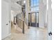 Elegant entryway with a grand staircase and tile flooring at 1257 Radiant St, Reunion, FL 34747