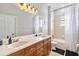 Bathroom with double sinks, a bathtub, and updated cabinetry at 1257 Radiant St, Reunion, FL 34747