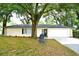 Ranch house with mature landscaping and large tree at 213 E Hillcrest St, Altamonte Springs, FL 32701
